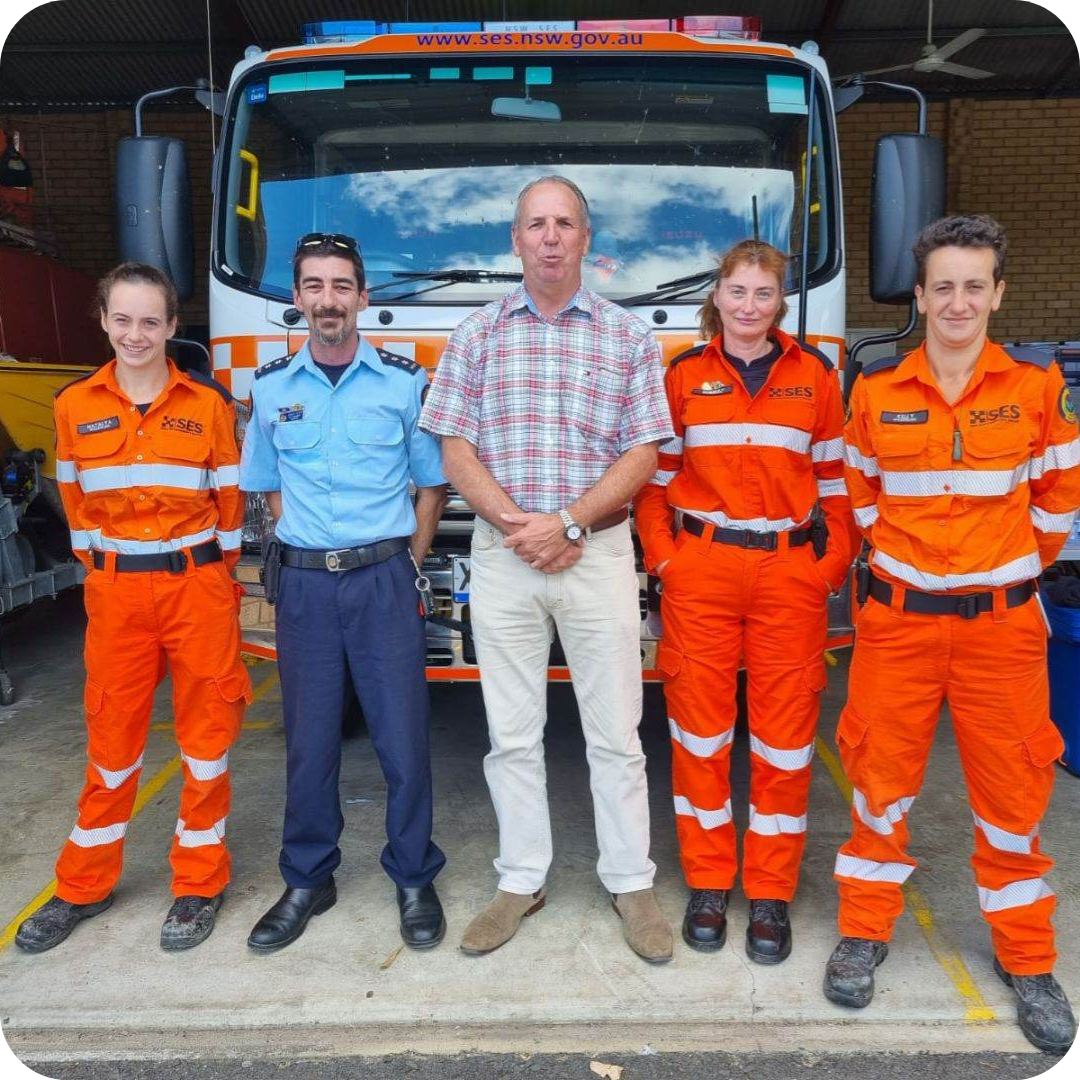 A group of people standing in front of a large truck of the SES at the Evans Head Campus